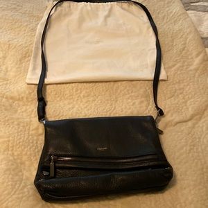 A Hammett crossbody bag in black leather, with 4 black studs on each side.